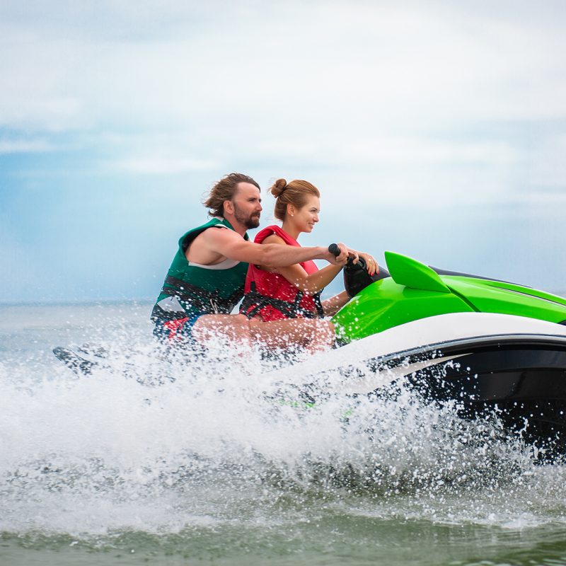 couple having fun on water scooter summer sea activity